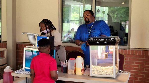 Serving Snow cones and popcorn