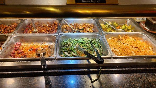 Dried out fried noodle, dry green beans, and something with sausahe