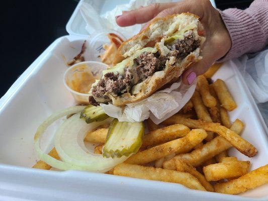 The half eaten burger, look at the thickness of that patty and those delicious fries!