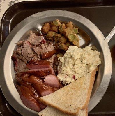 Sliced beef, smoked sausage, fried okra and potato salad.