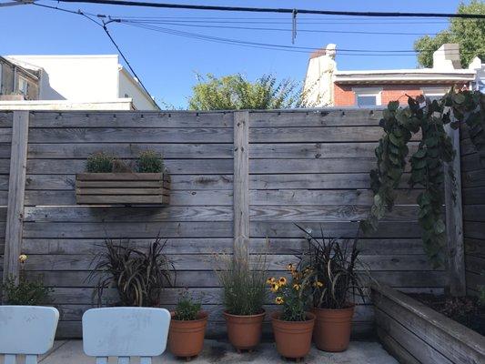 The "after" picture of the same clients overgrown pots after being replaced with ornamental grass and perennials.