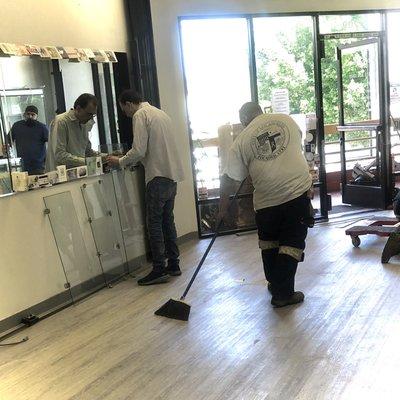 Sweeping up after installing the flooring.