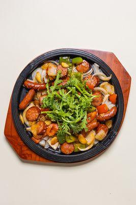 Korean stir-fried sausage on hot sizzling plate