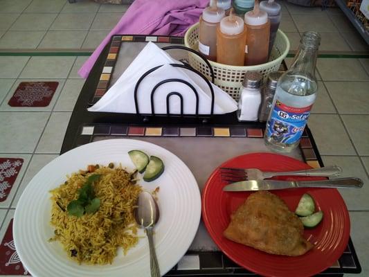 Vegetable biryani and a samosa.