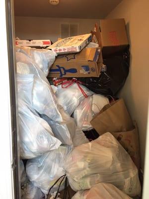 The trash room is completely full and spilling into the hallway.