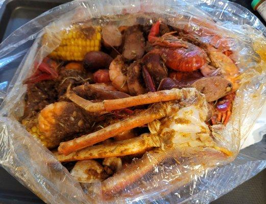 The Ultimate their sauce: Crawfish, Sausage, Clams, Shrimp, Snow crab, potatoes, and corn.