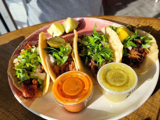 Various tacos served with tasty sauces - red is very spicy!