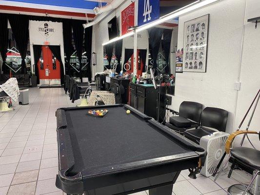 Pool table, sports flags and TVs all around.