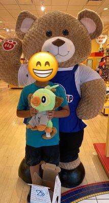 Posing for a picture in front of their giant bear with his new Pokémon friend :)