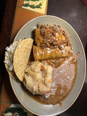 Combination plate. Taco, enchilada, tamale, beans and potatoes