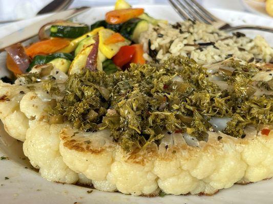 Cauliflower Steak topped with chimichurri served with Rice and Sautéed Green Beans with a Red Pepper Coulis