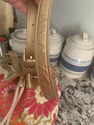 The gold on the straps of my Spartina bag bubbling and starting to peel