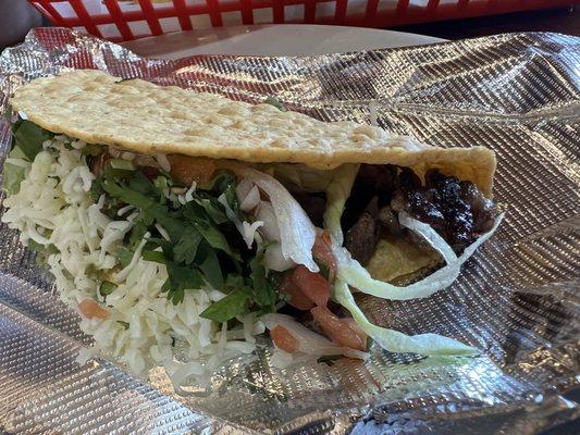 Carne asada taco with guacamole and pico