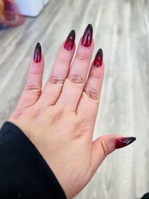 Ombré red and black manicure.