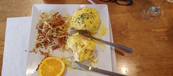 Eggs Benedict with hash browns.