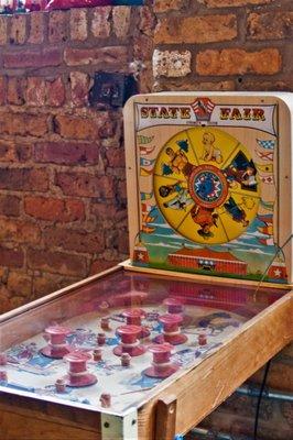 A vintage toy pinball machine, perfect to dress up a retro photo area.