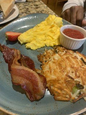 Two eggs hash browns and bacon