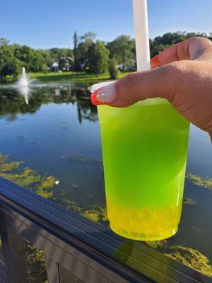 Honeydew bubble tea with mango bubbles.