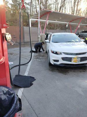 Employees "black shining" customer's vehicle tires and mine as well!