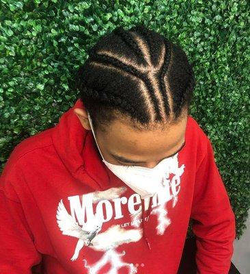 Young man with cornrows