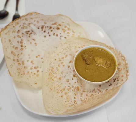 Appam with chicken curry