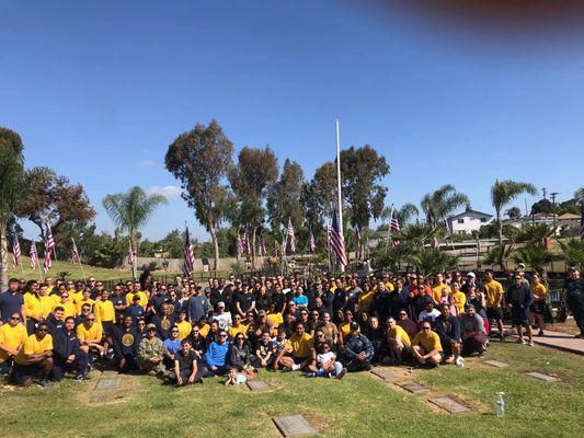 Memorial Day volunteers helping place U.S. flags on  veteran memorials