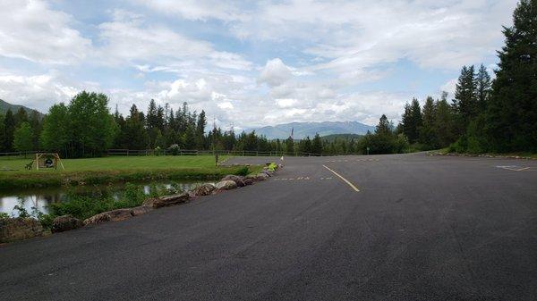 Entrance view with the trout pond on the left and Glacier NP in the distance