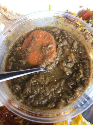 Lentil soup with uncooked carrots.