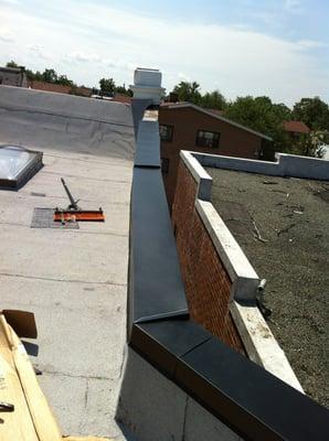 flat roof completed ,new membrane, metal copping, skylight