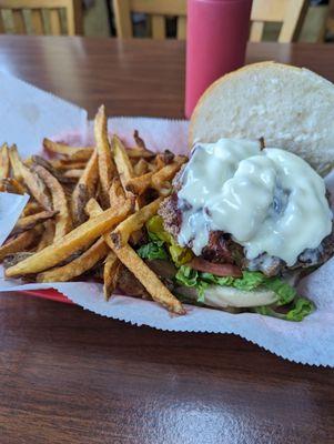 Bacon cheeseburger with lettuce tomato onion pickle. Bread is too big.