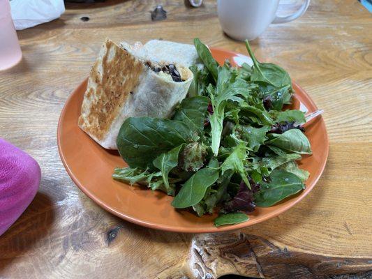 Shrimp burrito with side of greens.