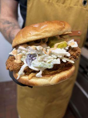 Dixie's Chick Sandwich- hand-breaded chicken tossed in a housemade spice blend, homemade slaw, pickles, provolone, SMASH sauce, brioche bun