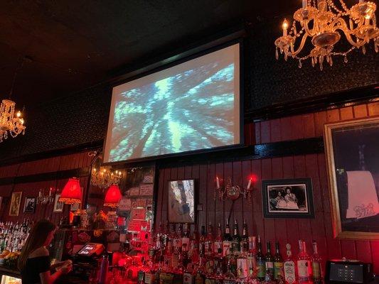 Old movies playing behind the bar