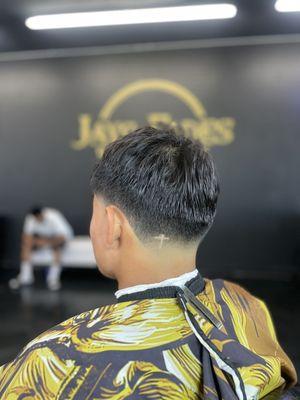 Jays fades barbershop offers a special haircut called a "Jays Fade" it comes with a free small design like you see in this picture.