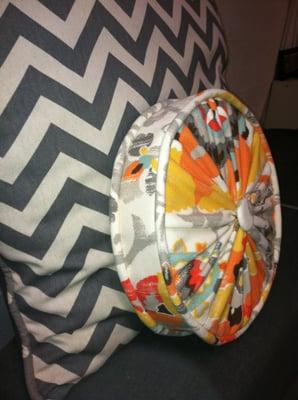 Round boxed pillow with piping, gathers and button.