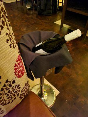 Wine holder next to the table with ice  ( nice touch)