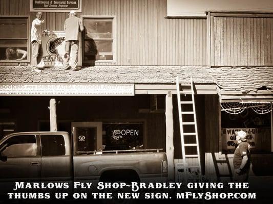 Hanging up the new Marlows Fly Shop sign in Dubois, Wyoming.