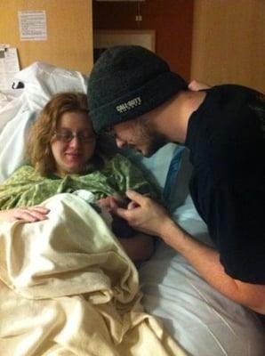 Daddy and mommy seeing their baby for the first time.