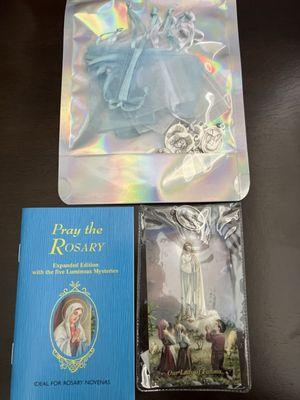 Our Lady Fatima Novena card, pray the rosary booklet and some Mary/Jesus sorrows medals to give as gifts.