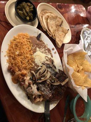 Steak Peurto Vallarta with chips and salsa jalapeños on the side