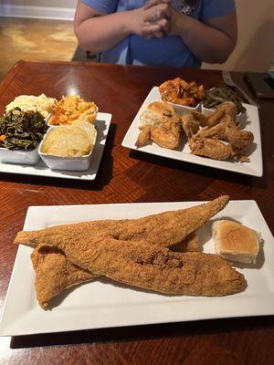 Friend chicken, fried fish, cabbage, greens, potato salad, mac n cheese, yams, and green beans.