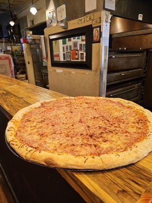 The 28" pizza pie with cheese. Each slice ordered is pulled out of it, and toppings are placed on top and then heated in the oven.