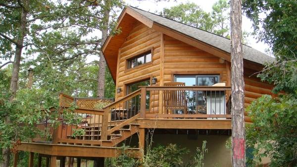 view of the back deck of the luxury log cabin where the hot tub can be found