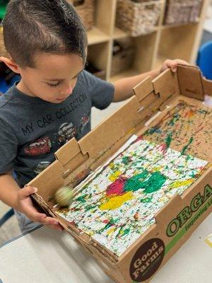 Golf Ball Painting-Children are practicing coordination and observation skills.