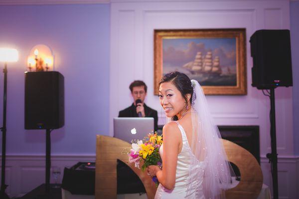 Fantastic DJ Sam Turner pictured in the background announcing bouquet toss at my FiDi (Manhattan NYC wedding). Yes, he is the absolute best!