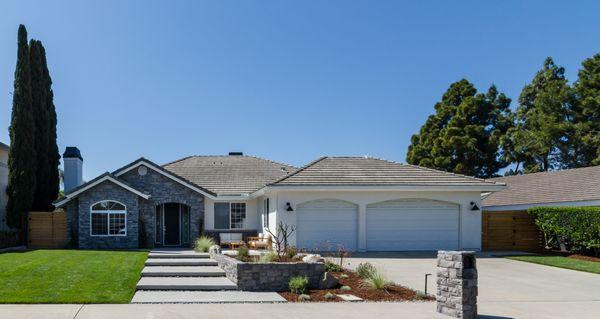 Curb Appeal. Custom Cedar side gates. Mailbox stone & custom wall to match stone on home. Cantilever steps for the entrance