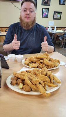 Erick with a mountain of Catfish