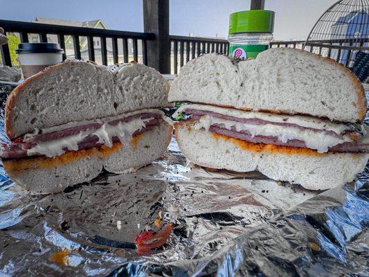 Pork roll & Cooper sharp with hot sauce on an everything bagel