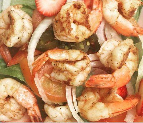 Grill Shrimp over lettuces, tomatoes, cucumbers & strawberries with Italian dressing.