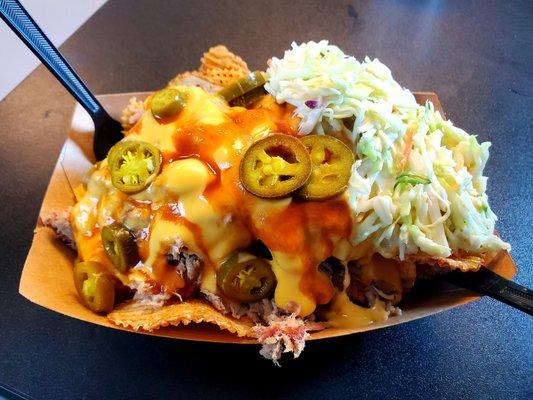 Pulled Pork Nachos: J-Mack chips, house slaw, house baked beans, nacho cheese, jalapenos and bbq sauce.